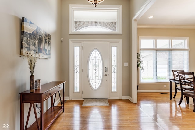 10784 Giselle Way, Fishers, IN 46040 - foyer entrance featuring light wood finished floors, baseboards, and ornamental molding