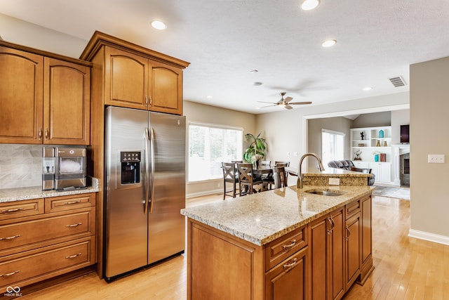 10784 Giselle Way, Fishers, IN 46040 - kitchen featuring stainless steel fridge with ice dispenser, a sink, ceiling fan, brown cabinets, and recessed lighting