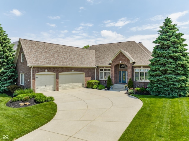10784 Giselle Way, Fishers, IN 46040 - view of front of house with a shingled roof, a front yard, driveway, brick siding, and an attached garage