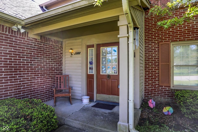 property entrance featuring brick siding