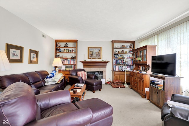 living room with light carpet and a tile fireplace