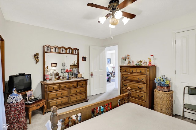 bedroom with light colored carpet and a ceiling fan