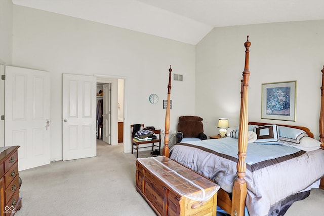 bedroom featuring light colored carpet and lofted ceiling