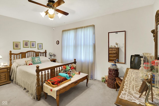 bedroom featuring light carpet and ceiling fan