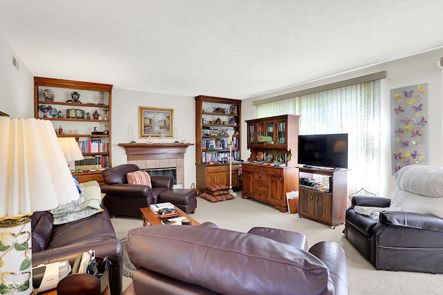 living room with light colored carpet and a tiled fireplace