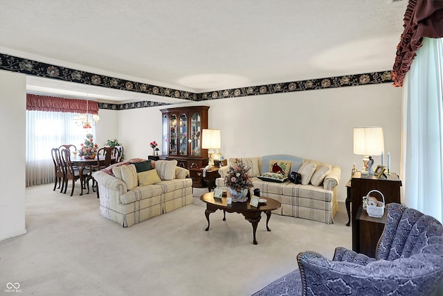 living area featuring carpet flooring and a chandelier