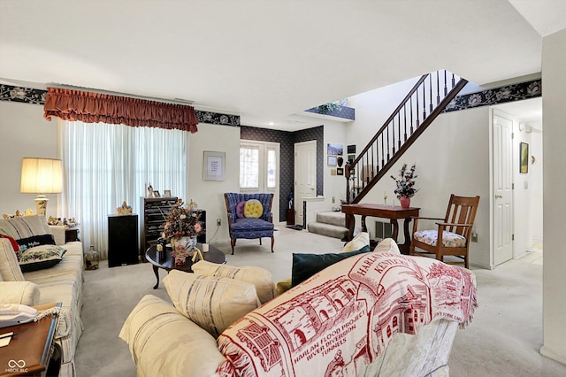 living room featuring carpet flooring and stairs