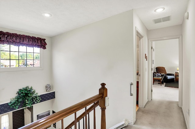 hall featuring an upstairs landing, recessed lighting, and baseboards