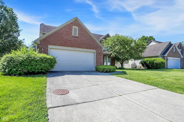 traditional-style house featuring brick siding, a front yard, concrete driveway, and a garage
