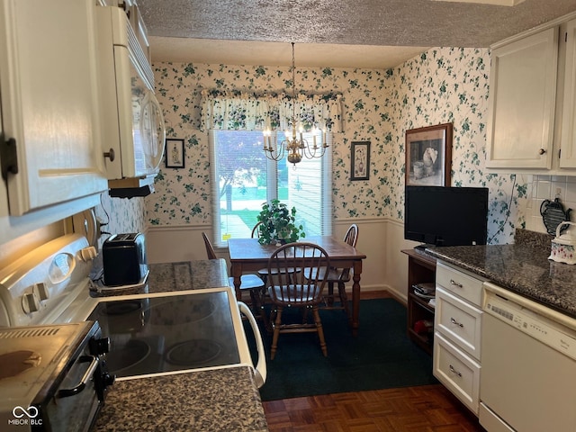 7440 Sylvan Ridge Rd, Indianapolis, IN 46240 - kitchen with white appliances, wallpapered walls, wainscoting, a chandelier, and a textured ceiling