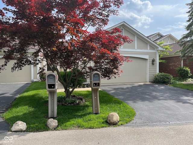 7440 Sylvan Ridge Rd, Indianapolis, IN 46240 - view of property hidden behind natural elements featuring driveway, a front lawn, and a garage