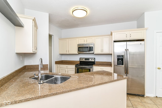 1030 Longwell Pl, Indianapolis, IN 46240 - kitchen featuring stainless steel appliances, a sink, cream cabinetry, and light stone countertops