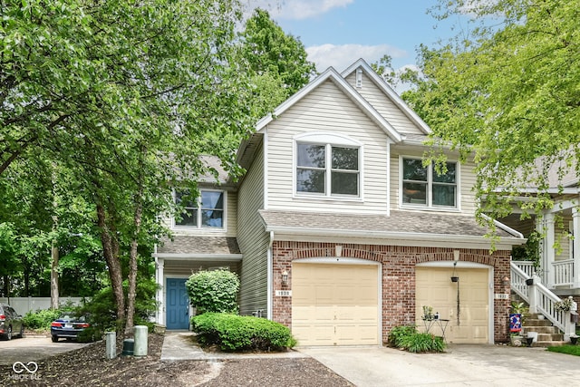 1030 Longwell Pl, Indianapolis, IN 46240 - view of front facade featuring a garage, driveway, roof with shingles, and brick siding