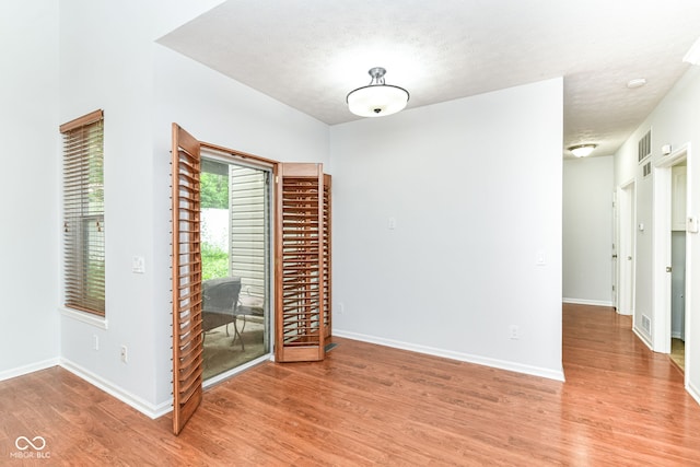 1030 Longwell Pl, Indianapolis, IN 46240 - unfurnished room with light wood-style flooring, baseboards, and a textured ceiling