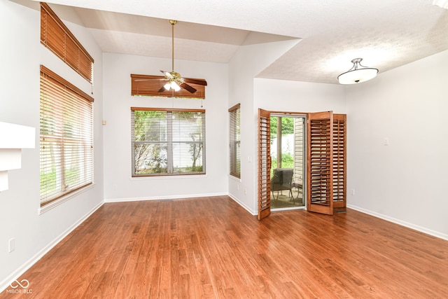 1030 Longwell Pl, Indianapolis, IN 46240 - spare room with wood finished floors, baseboards, ceiling fan, and a textured ceiling