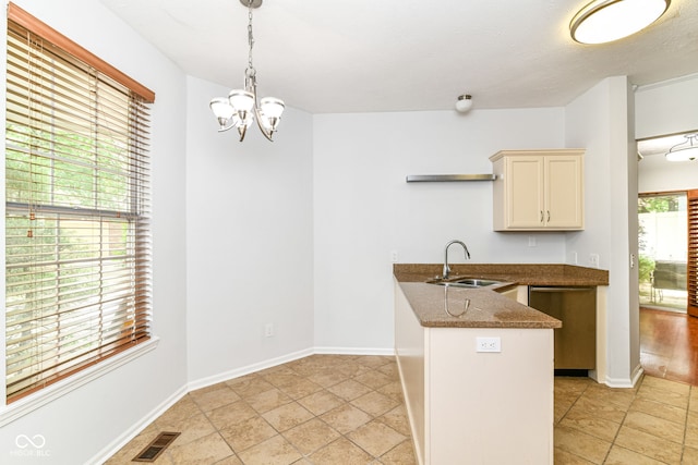 1030 Longwell Pl, Indianapolis, IN 46240 - kitchen featuring a sink, stainless steel dishwasher, a peninsula, dark stone countertops, and a chandelier