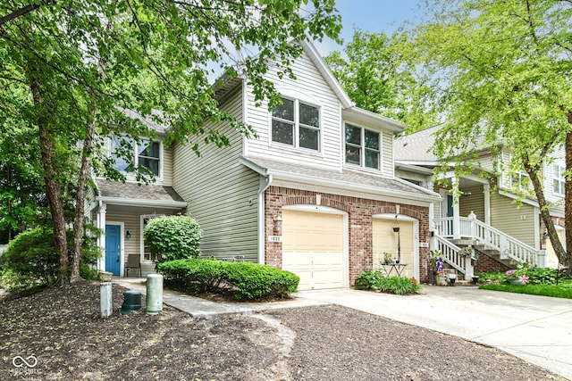 1030 Longwell Pl, Indianapolis, IN 46240 - view of property with an attached garage, concrete driveway, brick siding, and a shingled roof