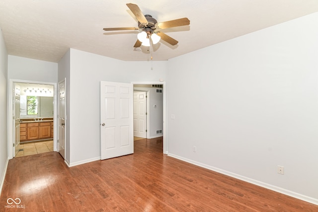 1030 Longwell Pl, Indianapolis, IN 46240 - unfurnished bedroom with light wood-style flooring, baseboards, ensuite bathroom, and ceiling fan