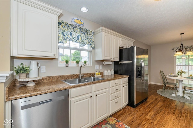 4256 Zachary Ln, Westfield, IN 46062 - kitchen featuring appliances with stainless steel finishes, a sink, dark wood-type flooring, white cabinetry, and a textured ceiling