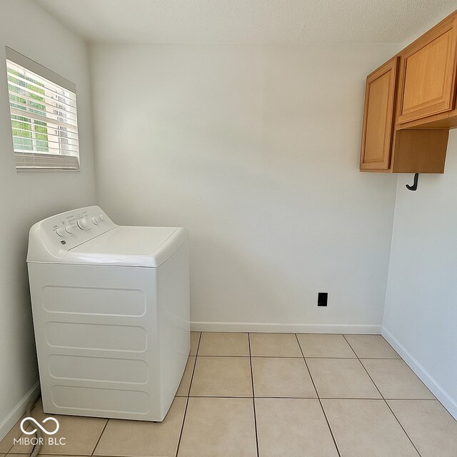 1332 W 26th St, Indianapolis, IN 46208 - laundry room with cabinet space, washer / clothes dryer, baseboards, and light tile patterned flooring