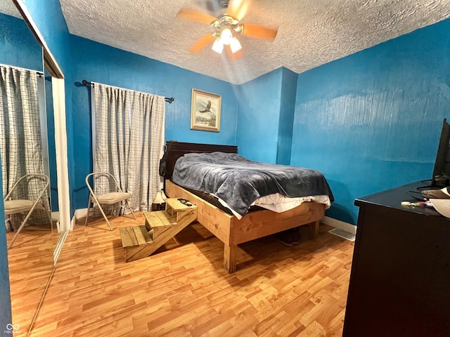 1332 W 26th St, Indianapolis, IN 46208 - bedroom featuring wood finished floors, a textured ceiling, and ceiling fan