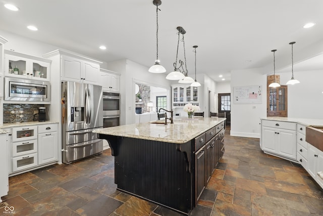 1478 W 500 S, Peru, IN 46970 - kitchen featuring appliances with stainless steel finishes, stone tile flooring, glass insert cabinets, white cabinetry, and recessed lighting