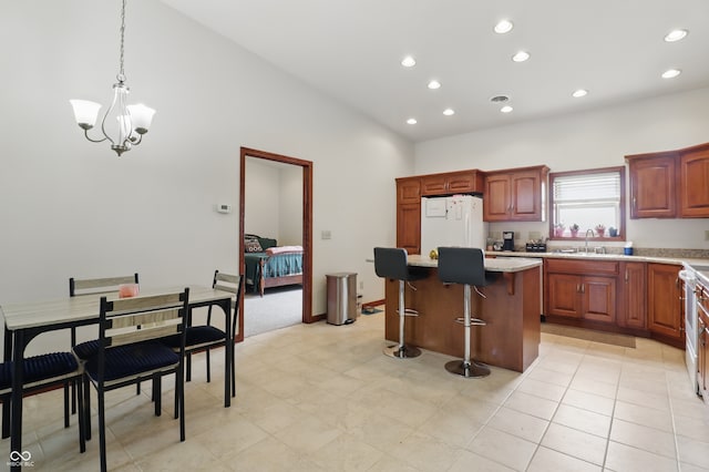 1478 W 500 S, Peru, IN 46970 - kitchen with a sink, white refrigerator, a kitchen island, recessed lighting, and high vaulted ceiling