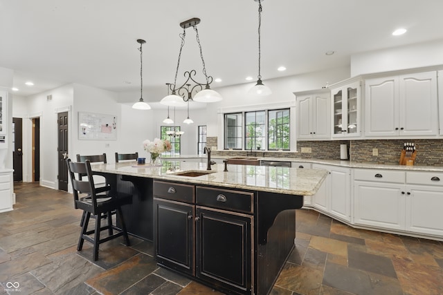 1478 W 500 S, Peru, IN 46970 - kitchen with a sink, stone tile flooring, backsplash, white cabinetry, and glass insert cabinets