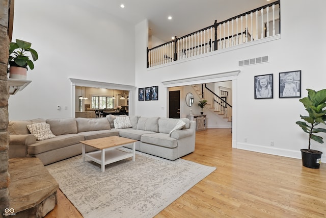 1478 W 500 S, Peru, IN 46970 - living area with a towering ceiling, wood finished floors, stairway, baseboards, and recessed lighting