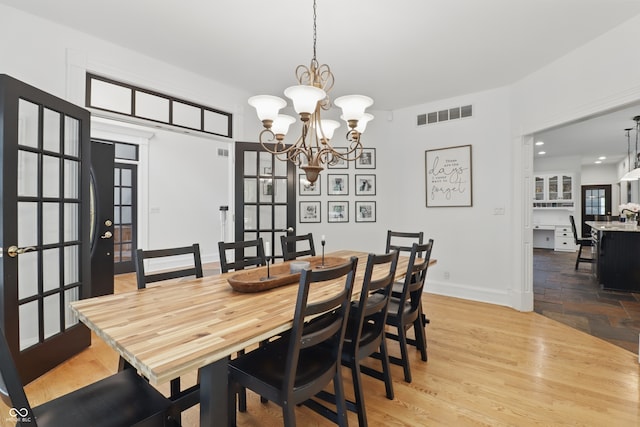 1478 W 500 S, Peru, IN 46970 - dining space with a chandelier, baseboards, and wood finished floors