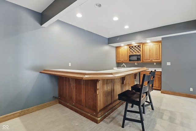 1478 W 500 S, Peru, IN 46970 - indoor wet bar featuring black microwave, recessed lighting, baseboards, and light colored carpet