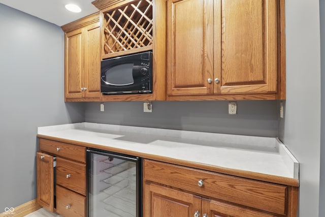 1478 W 500 S, Peru, IN 46970 - kitchen with wine cooler, black microwave, light countertops, and brown cabinets