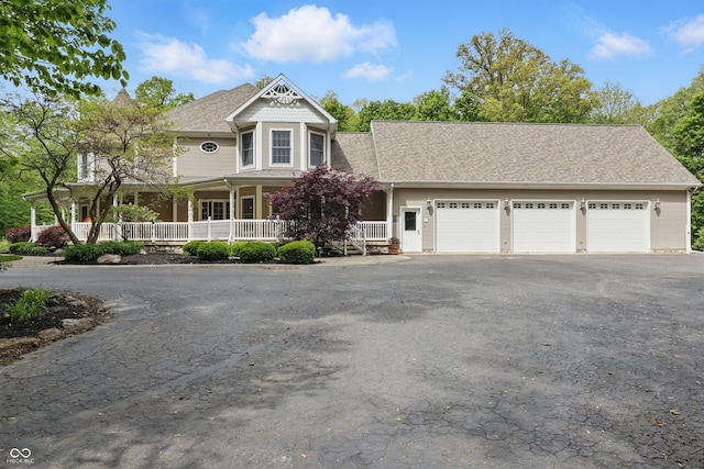 1478 W 500 S, Peru, IN 46970 - victorian home with driveway, covered porch, an attached garage, and roof with shingles