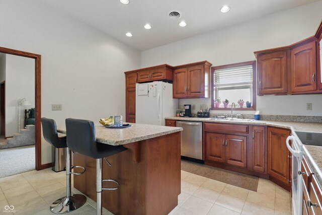 1478 W 500 S, Peru, IN 46970 - kitchen with white appliances, a sink, light countertops, a kitchen bar, and recessed lighting