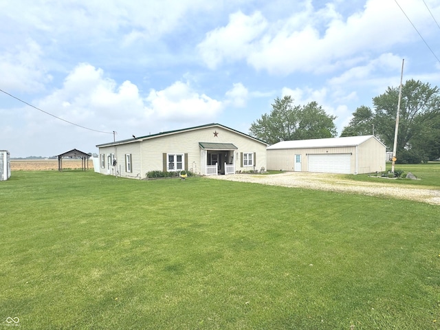 1123 S County Road 855 W, Greensburg, IN 47240 - view of front facade with a front yard, an outbuilding, a detached garage, and driveway