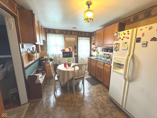 1123 S County Road 855 W, Greensburg, IN 47240 - kitchen featuring white refrigerator with ice dispenser, a sink, black microwave, brown cabinets, and wallpapered walls