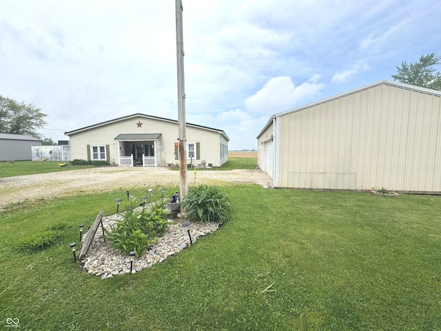 1123 S County Road 855 W, Greensburg, IN 47240 - view of grassy yard with driveway, an outbuilding, and a garage