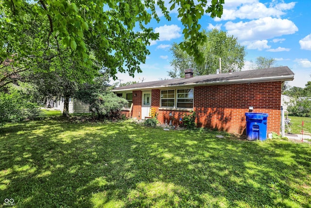 2200 N Dixon Rd, Kokomo, IN 46901 - back of property with brick siding, a yard, and a chimney