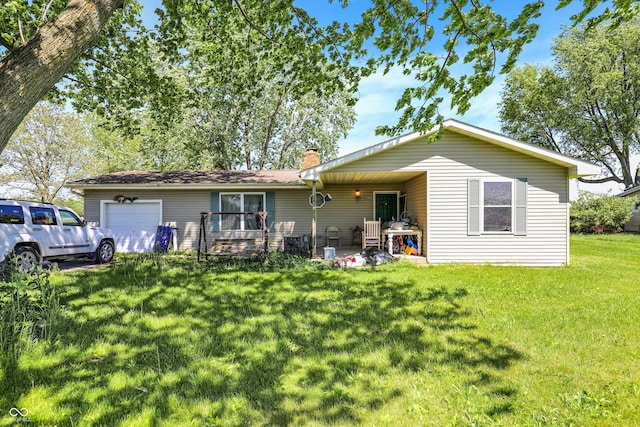2200 N Dixon Rd, Kokomo, IN 46901 - back of property with an attached garage, a yard, and a chimney