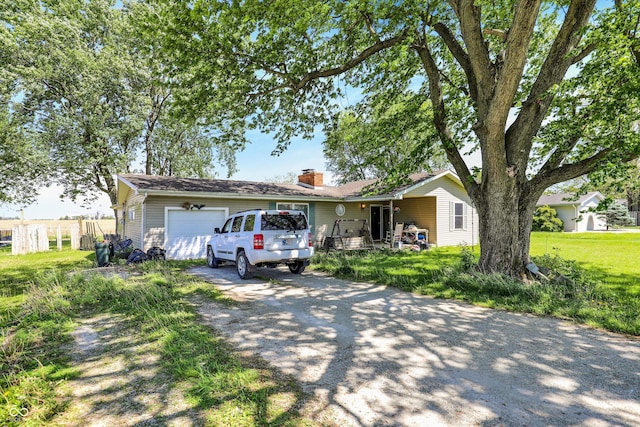 2200 N Dixon Rd, Kokomo, IN 46901 - single story home with driveway, an attached garage, and a chimney