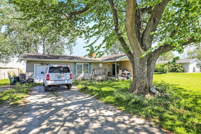2200 N Dixon Rd, Kokomo, IN 46901 - ranch-style house with driveway, a garage, a chimney, and a front lawn