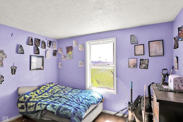 2200 N Dixon Rd, Kokomo, IN 46901 - bedroom featuring a textured ceiling, baseboards, and wood finished floors