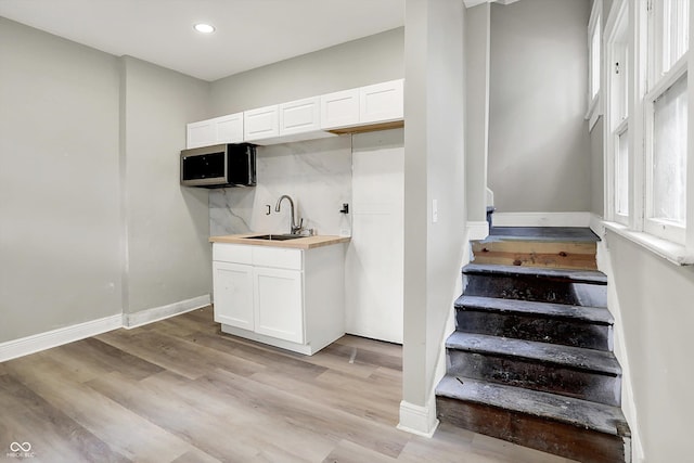 1033 N Dearborn St, Indianapolis, IN 46201 - stairs featuring wood finished floors, recessed lighting, wet bar, and baseboards