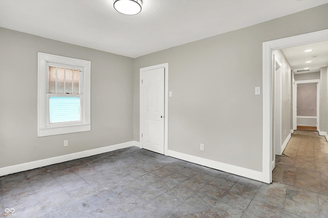 1033 N Dearborn St, Indianapolis, IN 46201 - empty room with baseboards and concrete floors