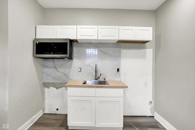 1033 N Dearborn St, Indianapolis, IN 46201 - kitchen featuring a sink, white cabinets, and dark wood-type flooring