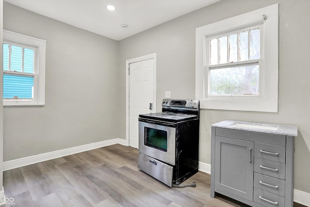 1033 N Dearborn St, Indianapolis, IN 46201 - kitchen featuring stainless steel electric range oven, gray cabinets, baseboards, light wood-style floors, and recessed lighting