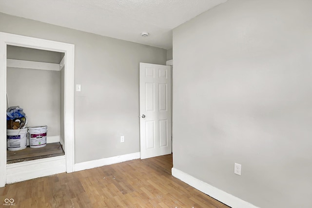 1033 N Dearborn St, Indianapolis, IN 46201 - unfurnished bedroom featuring baseboards and wood finished floors