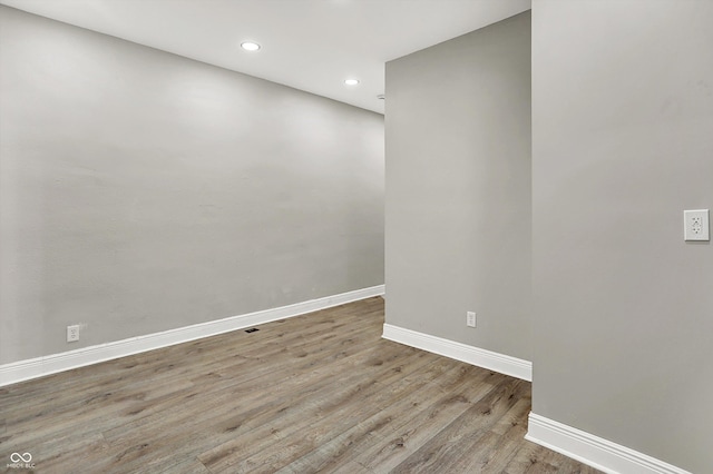 1033 N Dearborn St, Indianapolis, IN 46201 - spare room featuring baseboards, wood finished floors, and recessed lighting