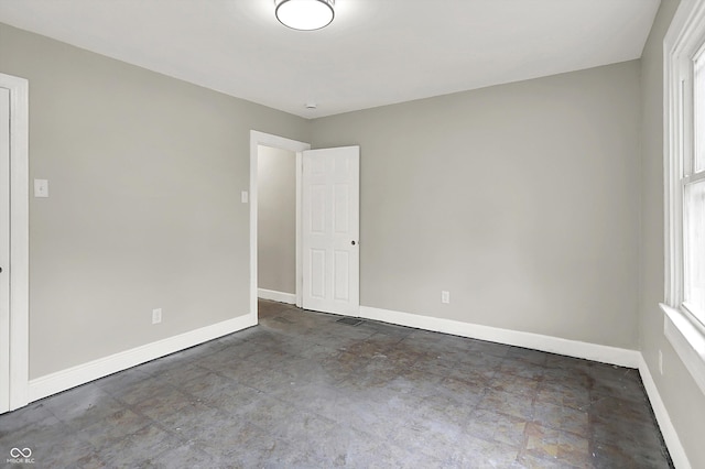 1033 N Dearborn St, Indianapolis, IN 46201 - spare room featuring baseboards