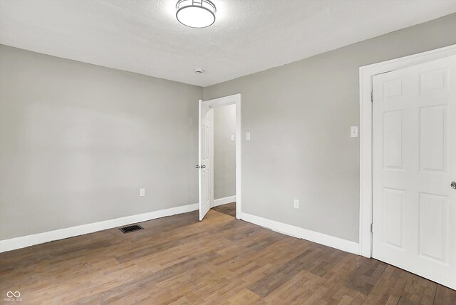 1033 N Dearborn St, Indianapolis, IN 46201 - unfurnished bedroom featuring baseboards and wood finished floors